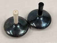 Top view of both shakers showing contrast stems and silverplate bodies