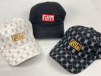 Three Flum caps grouped together showing colors and logos