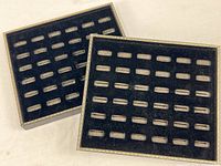 Both black velvet ring trays showing size and slot pattern