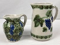 Two John B. Taylor stoneware pitchers side by side