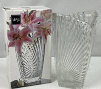 Vase standing next to its branded box