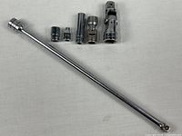 All six Snap-on pieces including extension rod, two universal joints and three sockets
