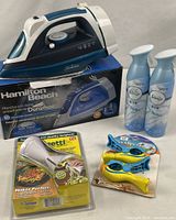 Group shot of all items: iron on box, Veggetti cutter, Boca Clips, two Febreze cans