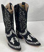 full view of both black nubuck embroidered boots