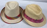 Both straw fedoras side by side displaying overall condition and bands