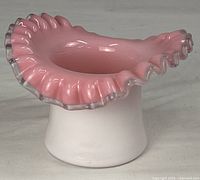 Front angle showing pink crest ruffled rim and top-hat form