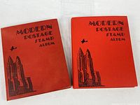 Two red Modern Postage Stamp Albums closed, cover design visible