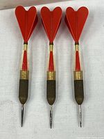 Full view of three darts showing flights and barrels