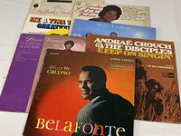 Front view showing six of the seven album covers partially overlapped