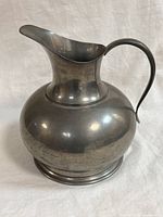 Front view of pewter pitcher showing shape and handle