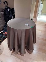 Table fully covered with taupe cloth