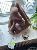 Cement abstract sculpture with wood cube art piece on windowsill