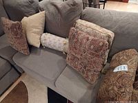 Group of six decorative pillows and one bolster on sofa