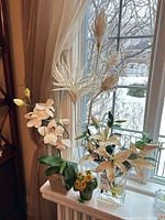 Group of faux plants on windowsill