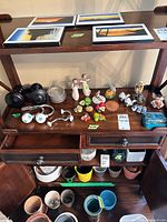 Shelf with full assortment of figurines, coasters, brackets, ceramic fruit, Delft shoes and other items