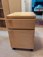 Front view showing both drawers, handles and casters