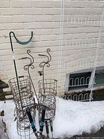 Group view showing plant rack, shepherd hook, two cage planters, loppers and shears