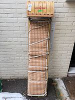 Full view of Mastercraft wooden sled leaning against wall