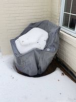 Chair and cushions under protective cover in snow