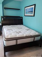 Full view of assembled queen bed with mattress in frame