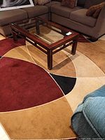 Rug on floor under glass coffee table showing geometric pattern and colors
