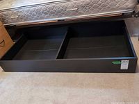 drawer pulled out showing two compartments under mattress