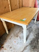 Full view of rectangular wood table with white legs