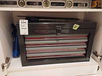 Closed cabinet on shelf showing overall toolbox