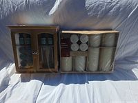 Front view showing boxed diffuser with oils beside sealed 10-piece candle set