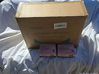 Outer master carton and two sample retail boxes displayed