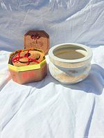 Burner next to box of coil incense showing exterior decoration