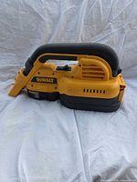 Left side view showing DeWALT branding, hose stored along top, nozzle attached