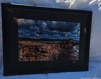 Full view of framed seascape photograph in black frame