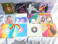 All twelve 7-inch records laid out showing picture and company sleeves