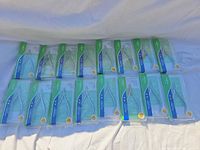 Sixteen packaged Nghia cuticle nippers laid out