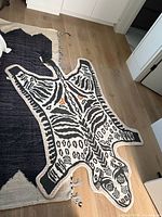 Full view of zebra-style rug on wood floor