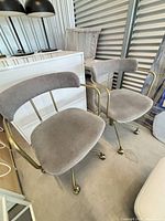Pair of gray fabric swivel chairs showing seats, backs, and frames
