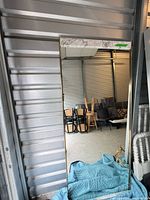 Full view of mirror leaning against wall