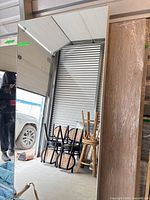 Front view of full-length rectangular mirror leaning against wall