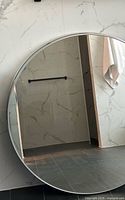 Front view of round metal framed mirror