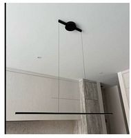 black linear bar pendant suspended from ceiling