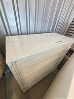 Dresser front and top wrapped in plastic