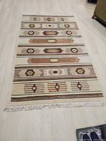 Full view of rug showing overall pattern, colors and fringe