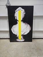 Full view of canvas artwork showing classical bust with yellow stripe