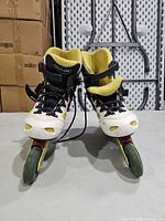 Front view of pair of Salomon inline skates showing boot color, laces, wheel setup