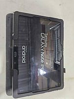 Front of tablet in case, screen powered on showing Samsung Galaxy Note screen