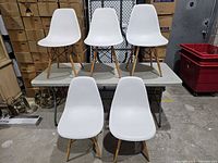 group shot of all five white chairs showing overall design