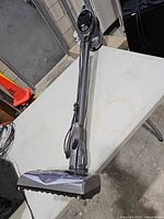 Full view of Shark Rocket corded stick vacuum with floor head and cord