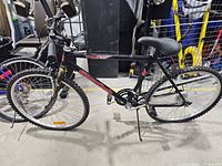 Left side view of entire black Supercycle 26" bicycle showing frame, wheels, drivetrain