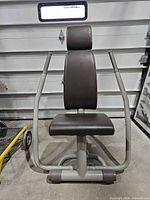 Front view showing gray frame, brown upholstery, push arms